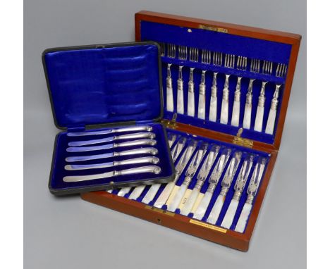 A cased set of silver handled pistol knives and a cased set of mother-of-pearl knives and forks