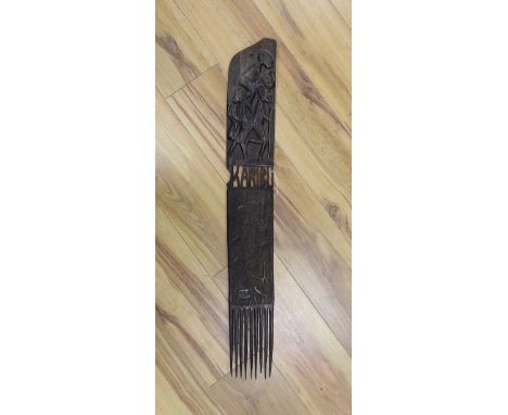 An African carved hardwood comb, Swahili83 cms long.