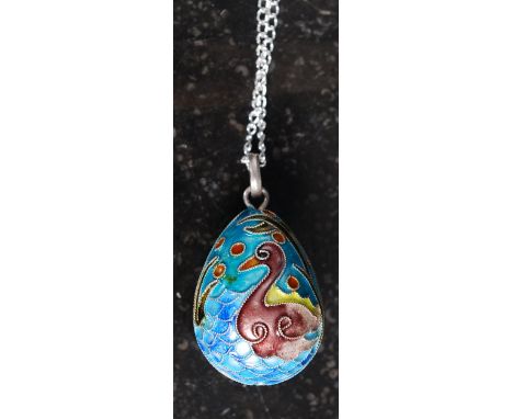 A white metal (stamped 925 indicating silver ) Faberge style enamel egg shaped necklace.  Weight 8.8 grams
