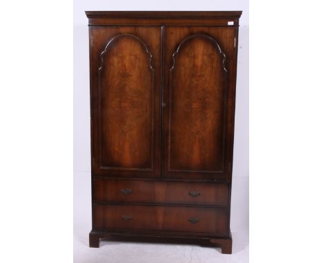 A 1940's Queen Anne walnut tallboy double wardrobe raised on bracket feet with twin full length doors having hanging space wi