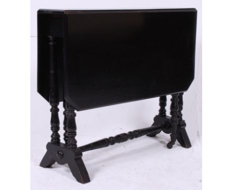 A Victorian 19th century ebonised mahogany sutherland table.  Raised on ring turned supports with ceramic castors. Drop leave