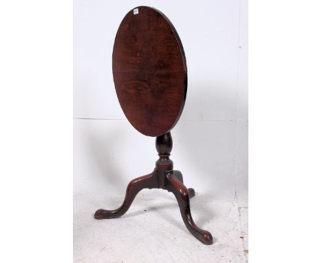 A late 18th century mahogany tilt top wine table. Raised on tripod base with splayed feet, turned column and circular tilt to