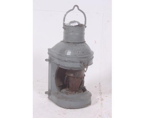 A vintage large industrial ships masthead lantern complete with the original makers plate ( no glass).  H50cm x W24cm x D21cm