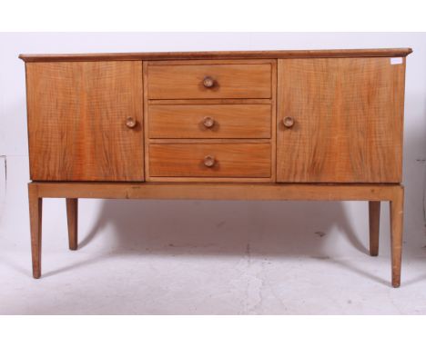 An original Gordon Russell walnut sideboard / dresser. Raised on squared legs with a chest to centre flanked by end cupboards