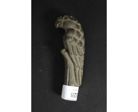 A bone walking stick handle in the form of a parrot