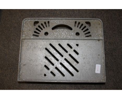 A vintage industrial metal Cooks ' Supra Trolley Kneeler ' - cast iron base plate with wooden roller wheels to base.