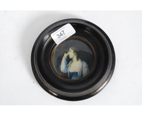 A 19th century miniature painting 3/4 portrait oleograph of a lady and spyglass. Ebonised frame with paper label bearing nota