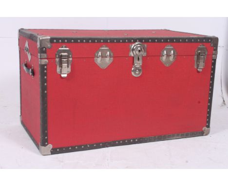 A large vintage steamer trunk hinges and lock to front finished in red.  H52cm x W97cm x D52cm