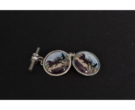 A pair of white metal (stamped 925 indicating silver ) and enamel set cufflinks