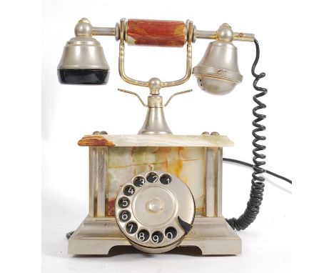 A retro onyx table telephone with ring dial to front. 