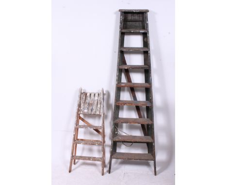 2 vintage 20th century wooden ladders having trestle supports, one large, one smaller ( see illustration )