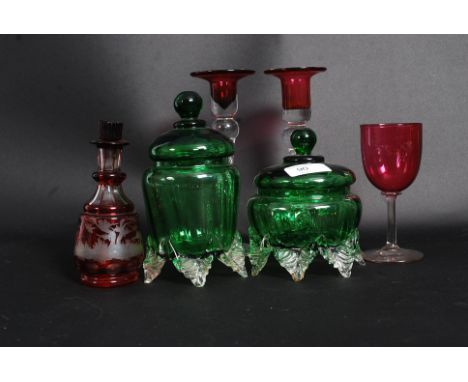 A  collection of colourted glass to include 2 green glass sweet jars both with lids together with cranberry glass twist candl