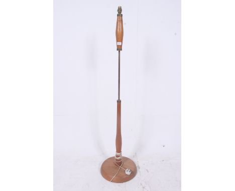 A good 1970's retro teak and brass G-Plan standard lamp having terraced base with brass and shaped teak upright complete with