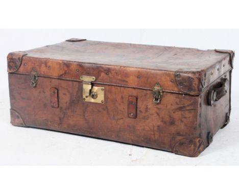 A substantial 19th century leather suitcase / steamer trunk having leather strap carry handles with monogram atop P.G.P.  H30