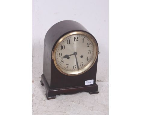 An early 20th century English dome cased bracket mantle clock having an eight day movement set within a mahogany case having 