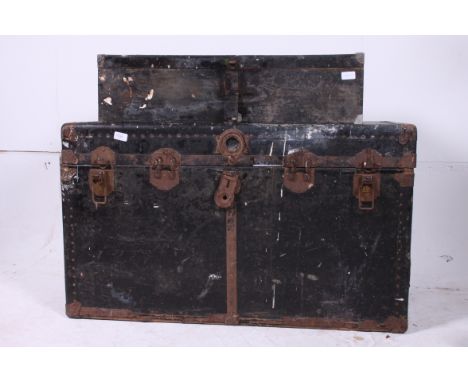 A large 20th century vintage steamer trunk in black having hinged clasps together with another