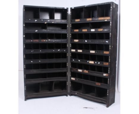 A pair of  original mid 20th century Industrial large dark  enamel metal sectional cubby cabinet. The cabinets each having  m