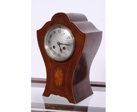An Edwardian mahogany inlaid balloon clock having roman number chapter ring to the silvered dial. The movement marked Depose 