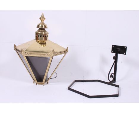 A contemporary large antique style brass lantern of oversized form complete with wall mount. 82cm x 65cm diam