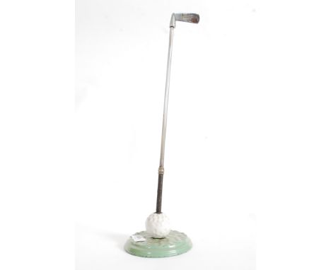 An unusual 1930's enamel painted fire poker in the form of a golf club complete with the stand