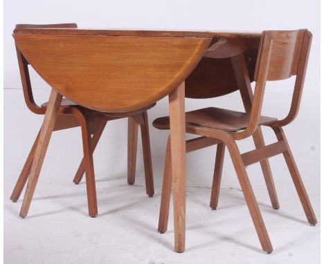 A 1970's Ercol golden dawn drop leaf dining table together with 2 panel back industrial 1950's school chairs. H72cm x W104cm 