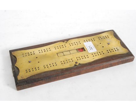 A good 19th century oak and brass crib / cribbage board having a suit sliding panel to centre for Hears, Diamonds, Clubs & Sp