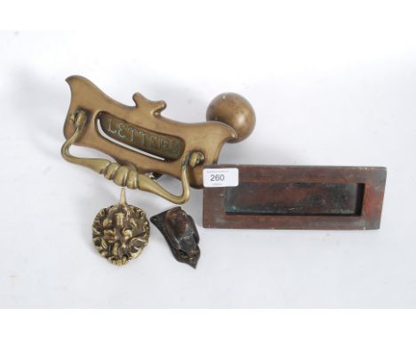 A collection of Victorian and other door furniture to include a brass letterbox with handle, lion mask mount and other knocke