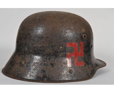 An original WWII Second World War German Nazi soldier helmet. Retaining some original black paint, with later added Swastika 