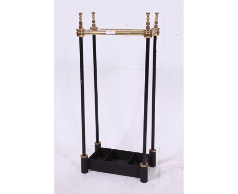 A Victorian style ebonised tubular metal brass umbrella / stick stand having tray base with finials atop