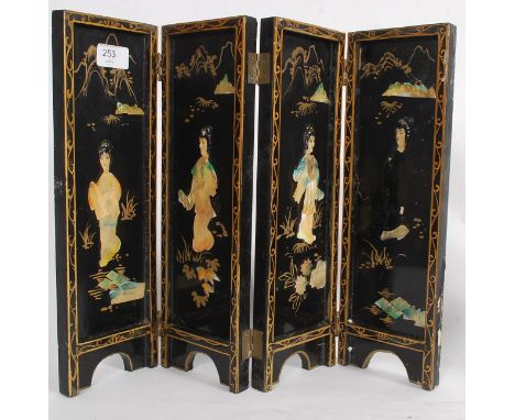 A Japanese black laquered 4 fold table top screen having painted decoration with abalone / mother of pearl insets