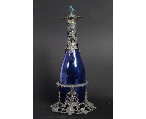 A Bristol Blue decanter in decorative grape and vine stand