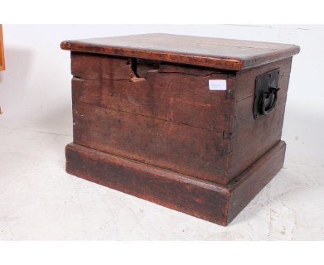 A 19th century elm blanket box chest trunk. Of square form with cast iron handles with flared top above