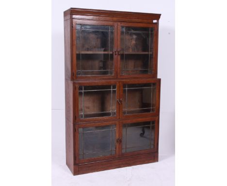 A 1930's Oak lawyers stacking bookcase library cabinet. The oak sectional bookcase in the manner of Globe Wernicke having lea