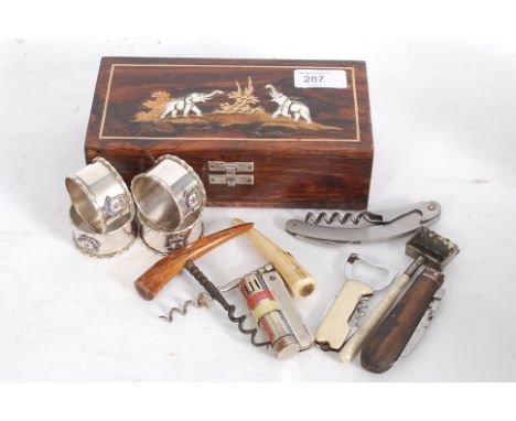 A good mixed lot to include an Inlaid elephant box, lighter and collection of corkscrews.