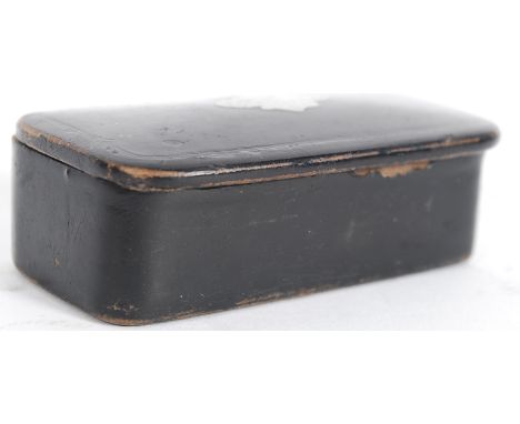 A  19th century papier mache snuff box with hinged lid having inset silver cartouche