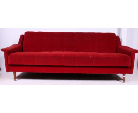 An amazing 1950's retro original upholstered red velour sofa settee / day bed. Raised on turned teak wood legs with red butto