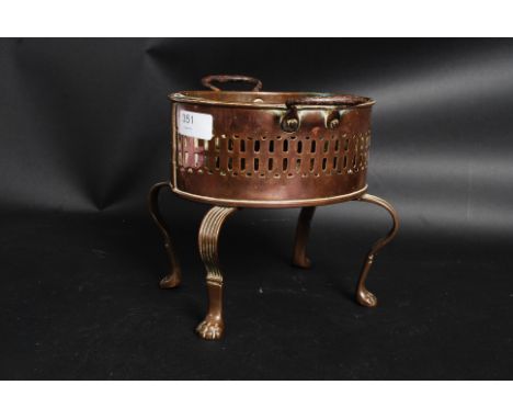 A 19th century Georgian copper brazier having shaped tripod supports with fret pierced oval body above