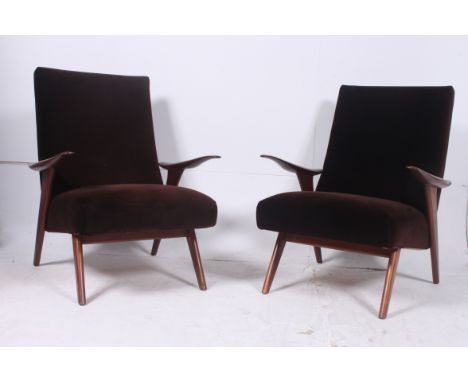 A pair of  original 1970's Greaves & Thomas teak and velour upholstered armchairs. The chairs being raised on tapered support