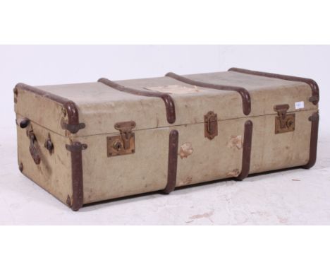 An early 20th century canvas and wooden strapped steamer trunk - ideal as coffee table conversion.  H31cm x W91cm x D51cm