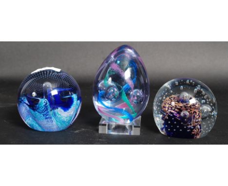 A collection of paperweights to include Caithness and other examples