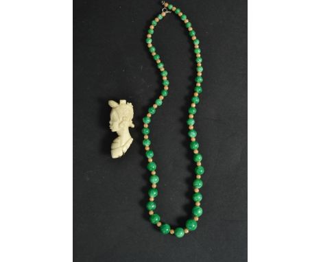A Chinese Jade and pearl Chinese necklace on string with clasp together with a bone brooch of a lady