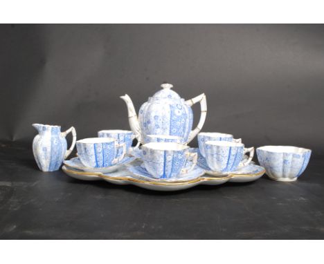 A 19th century Charles Wileman china tea service of lobed shape, printed in blue and white with  foliate detailing. Comprisin