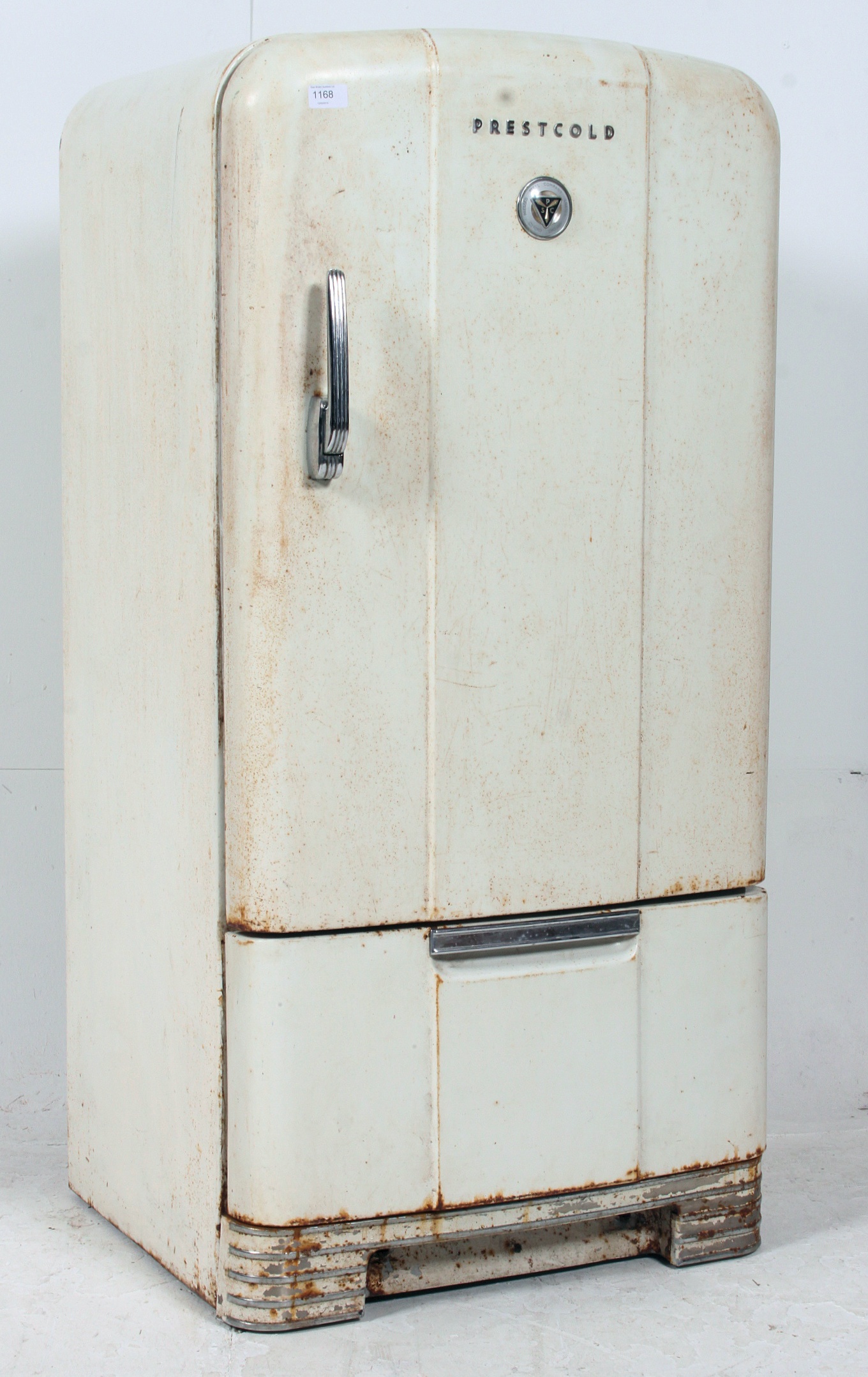 A vintage 1950's Prestcold fridge having the original enamel painted