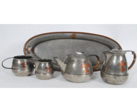A 19th century Arts & Crafts pewter and copper overlaid tea and coffee set  in the manner of Liberty / Tudric. Comprising tea