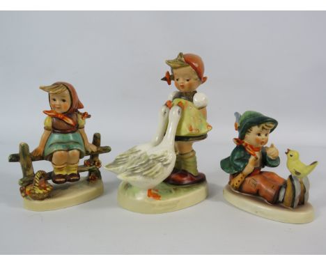 Three Goebel Hummel figurines.