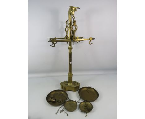 Set of vintage Portugese double balance brass scales with bulls head design with weights, 25" tall.