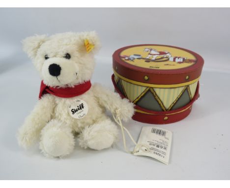 Steiff teddy bear Charly with a trommel box.