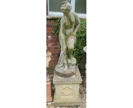 Reconstitued Weathered Stone Statue which measures 40 inches which stands on a Stone plinth of 21 inches tall. THIS ITEM IS T