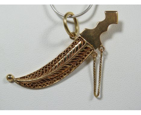 18ct Yellow Asian Gold Dagger Pendant with safety chain fitted. Filligree Scabbard 50 mm long. Total Weight 6.3g (chain not i