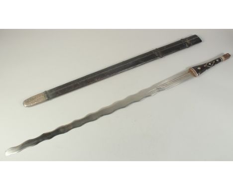 AN UNUSUAL OMANI SWORD AND SCABBARD, the sword with fullered jagged blade, silver threaded leather overlaid handle, and leath